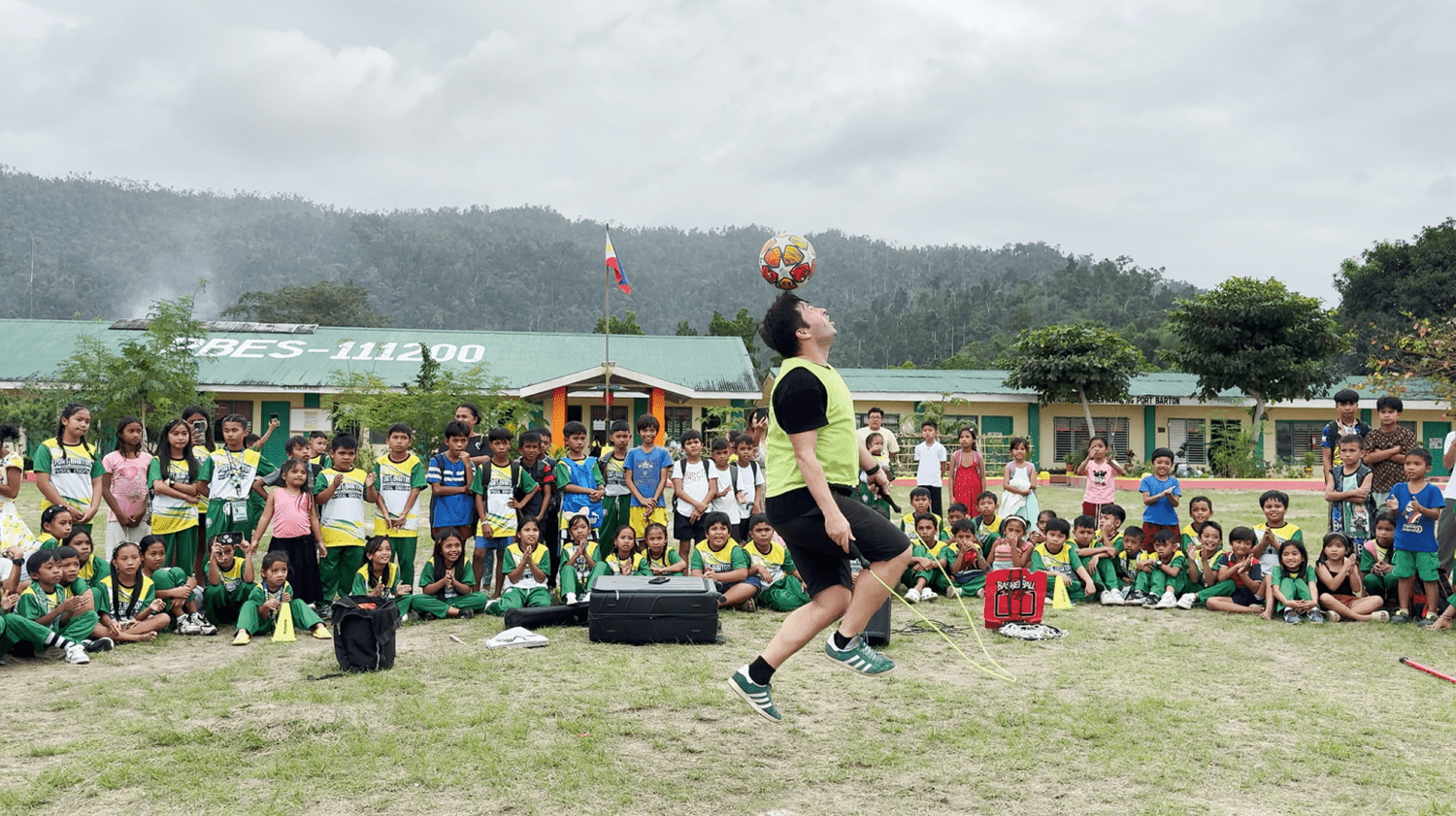 A football trick in a mountain schoolyard