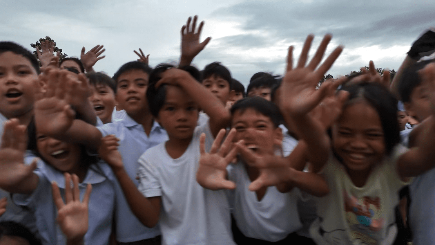 Children reaching toward the camera
